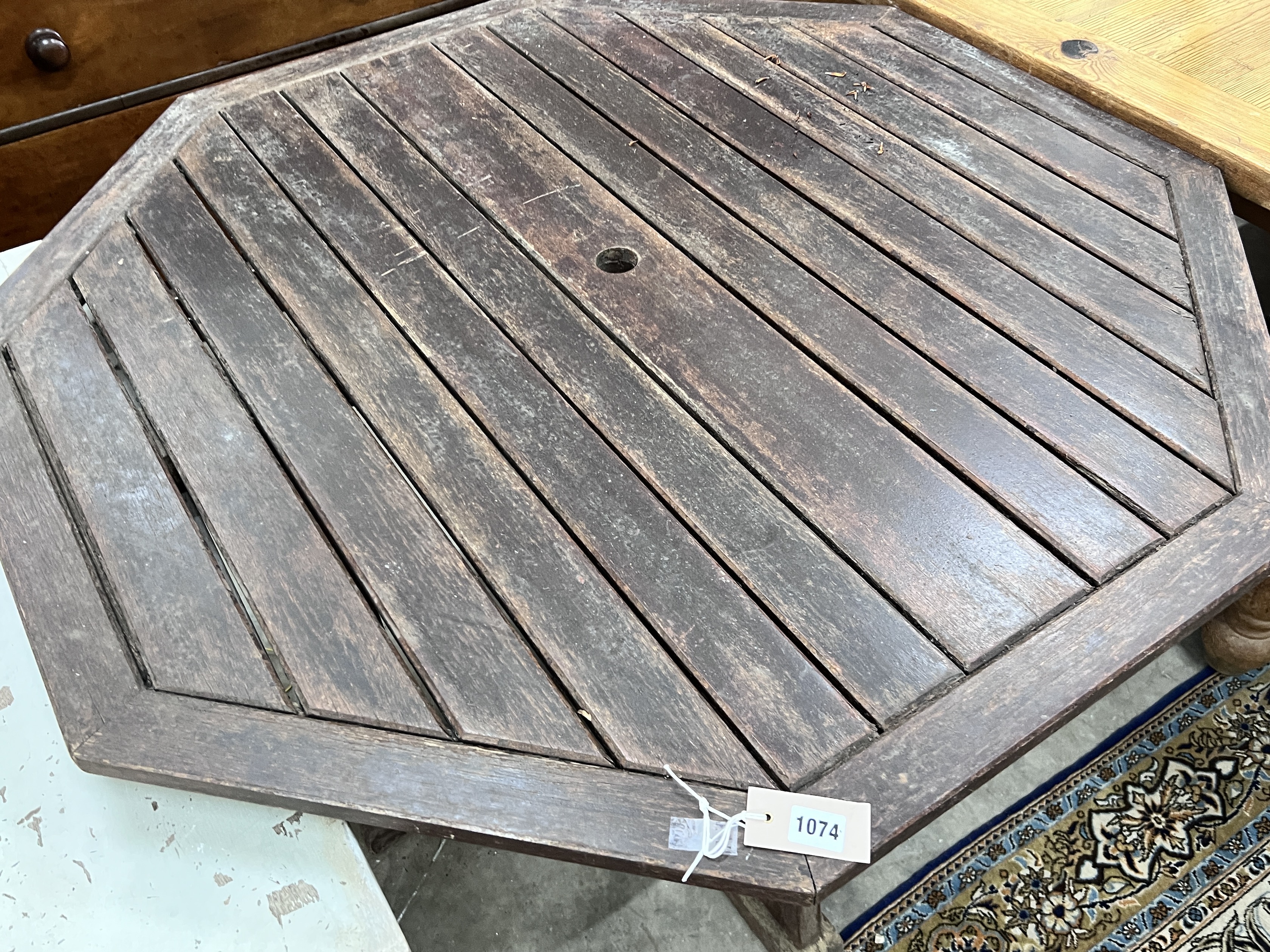 An octagonal teak garden table, width 111cm, height 75cm